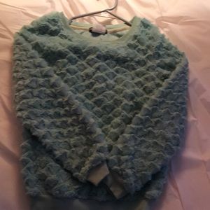 A mint green fuzzy sweater